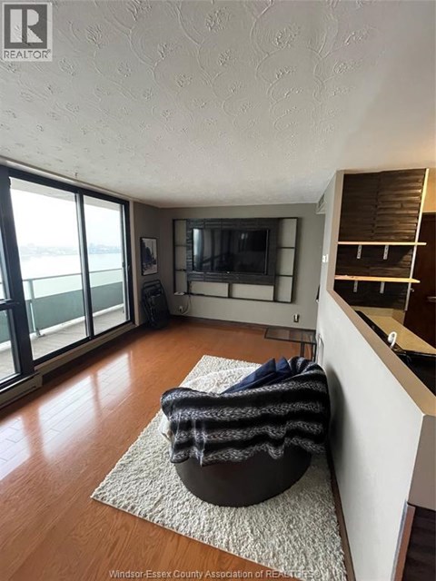 A living room with a chair and a television.