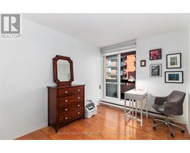 A bedroom with a dresser and a mirror.