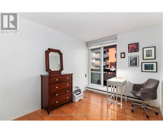 A bedroom with a dresser and a mirror.
