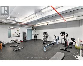 A gym with a variety of equipment including a treadmill, weights, and a stationary bike.