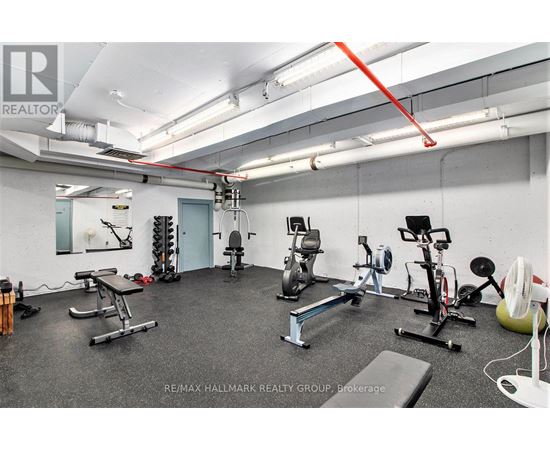 A gym with a variety of equipment including a treadmill, weights, and a stationary bike.