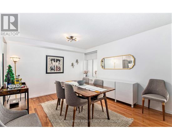 A dining room with a wooden table and grey chairs.