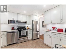 A kitchen with white cabinets and stainless steel appliances.
