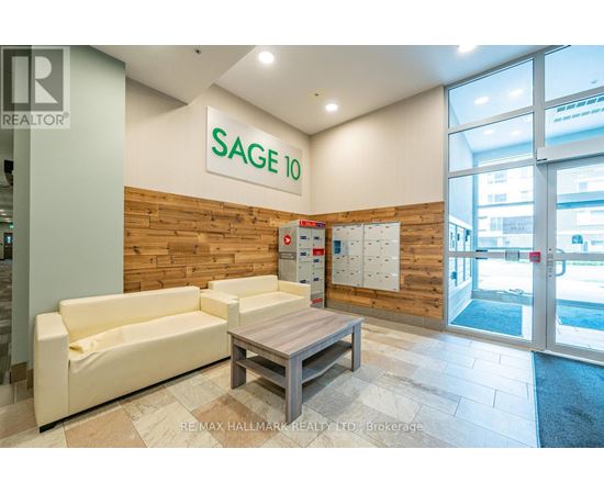 A white sofa and table are in front of a wooden wall with a sign that says SAGE 10.