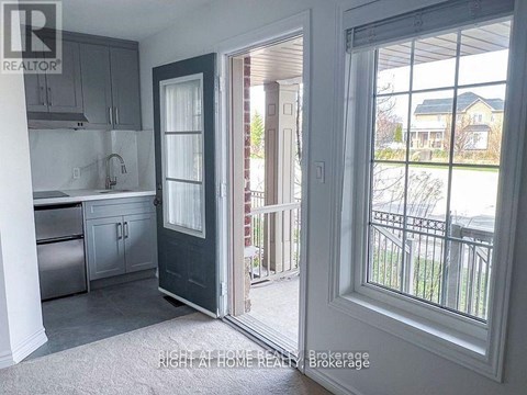 A kitchen with a sink and a door leading to a balcony.