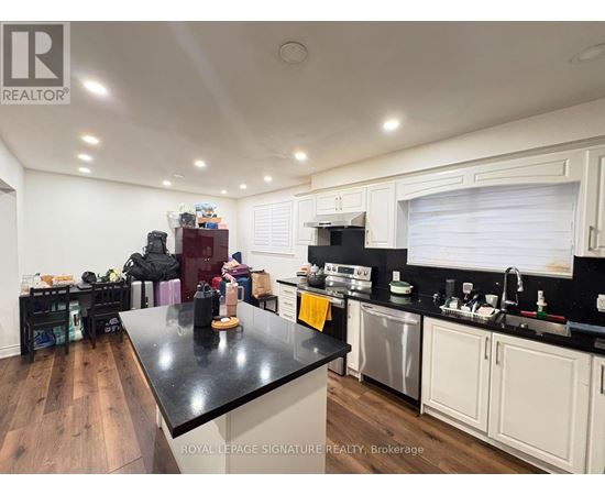 A kitchen with a black countertop and white cabinets.