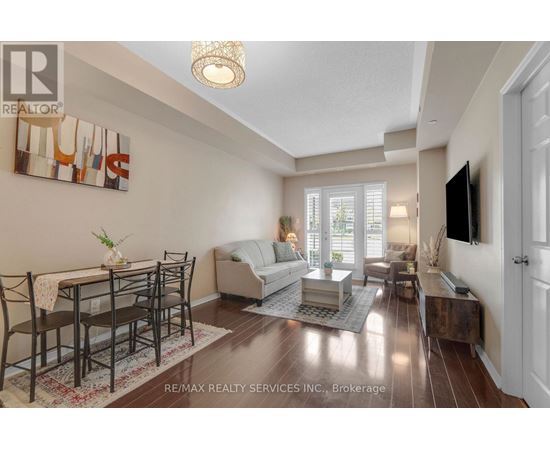 A well-lit living room with a dining table and chairs.