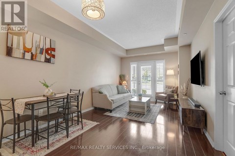 A well-lit living room with a dining table and chairs.
