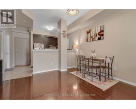 A dining room with a table set for four.