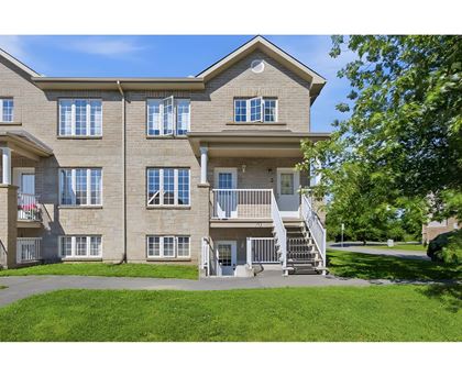 A large apartment building with a staircase leading to the entrance.