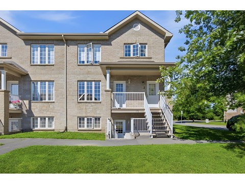 A large apartment building with a staircase leading to the entrance.