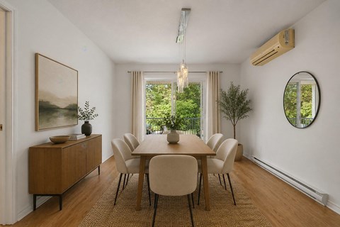 A dining room with a wooden table and chairs.