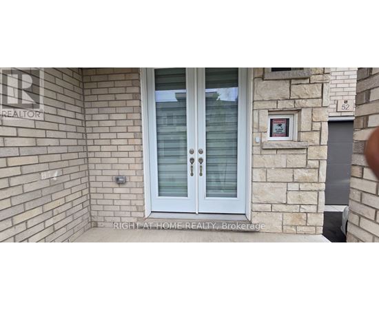 A glass door with a handle is on a stone wall.