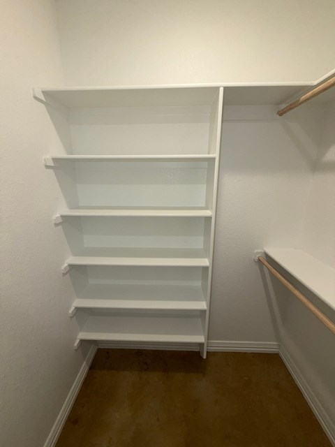 Empty white shelves in a room.