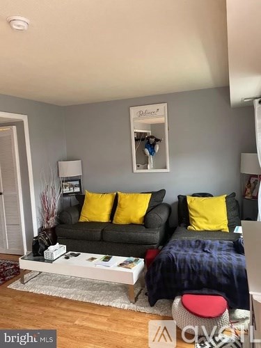 A living room with a grey couch and a coffee table.