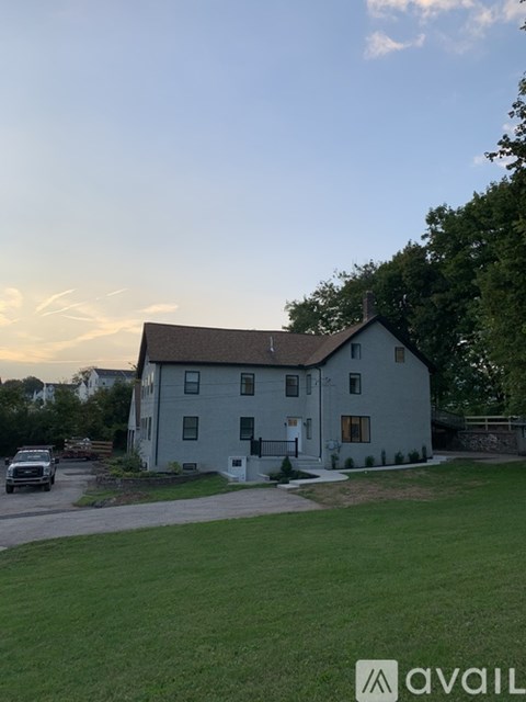 A house with a car parked in front of it.