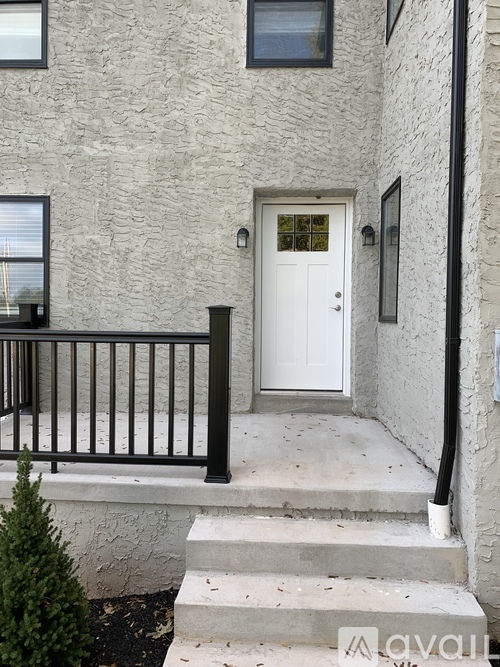 A white door is on the front of a house.