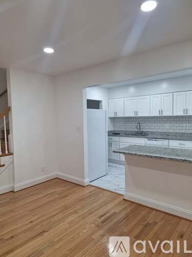A kitchen area with a white cabinet and a countertop.