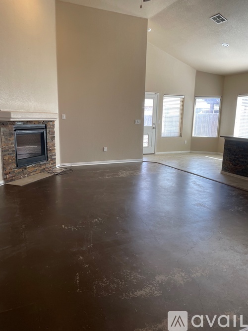 A spacious living room with a fireplace and a television.