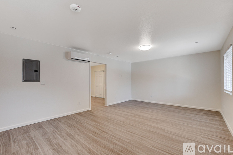 A room with wooden flooring and a white ceiling with a light fixture.