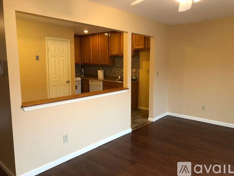 A kitchen with wooden cabinets and a white door.