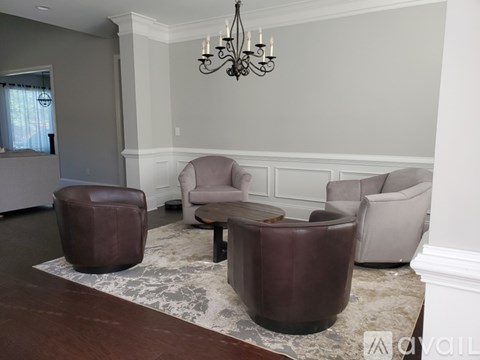 A living room with a brown leather chair and ottoman.