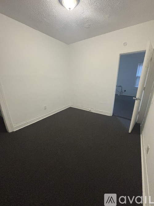 A room with a door and a light on the ceiling.