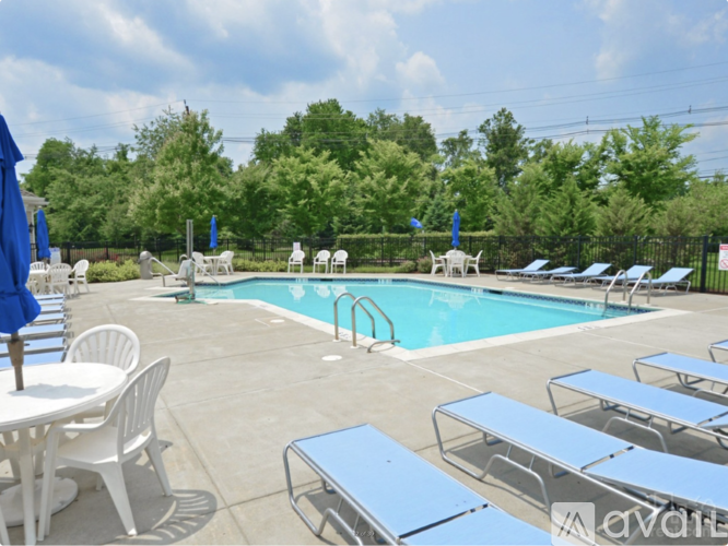 A pool area with sun loungers and a table.