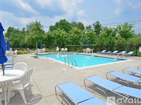 A pool area with sun loungers and a table.