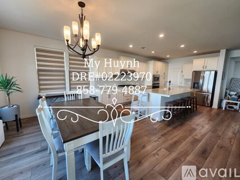 A dining room with a wooden table and chairs is shown in the image.