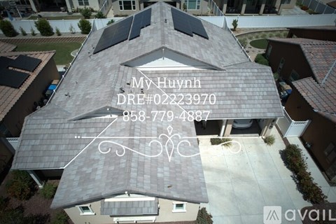 A house with solar panels on the roof and contact information overlaid.