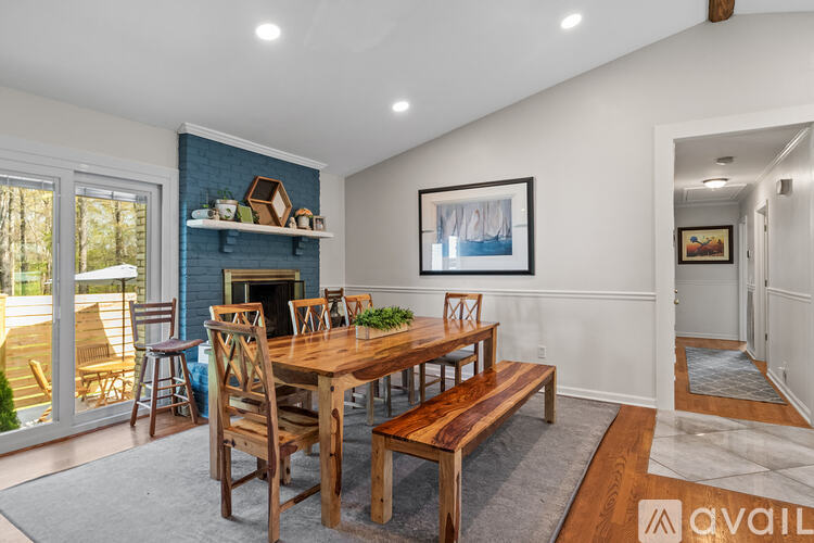 A dining room with a wooden table and chairs.