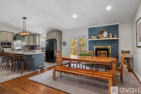 A modern kitchen with a wooden table and chairs.