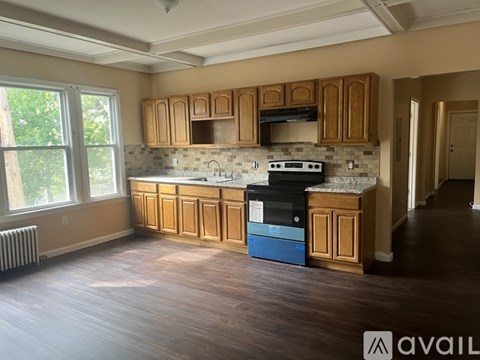 A kitchen with wooden cabinets and a blue dishwasher.