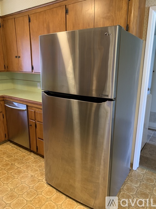 A stainless steel refrigerator in a kitchen.
