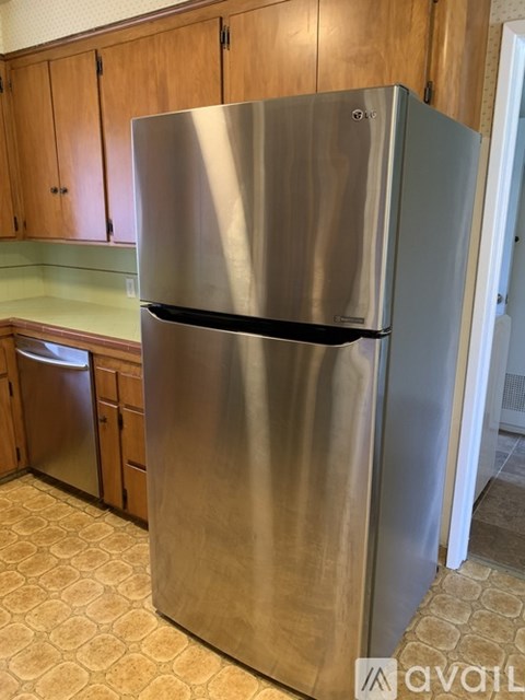 A stainless steel refrigerator in a kitchen.