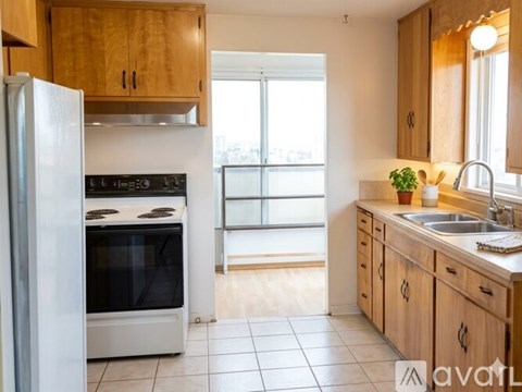 A kitchen with wooden cabinets and a white refrigerator.