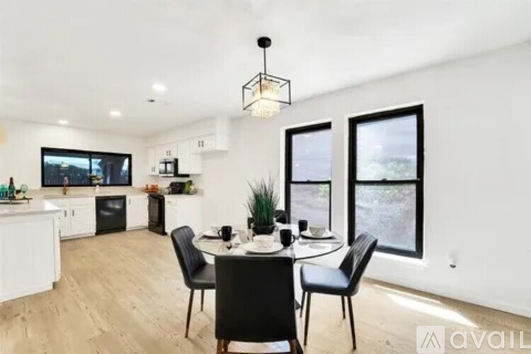 A modern kitchen with a dining table set for four.