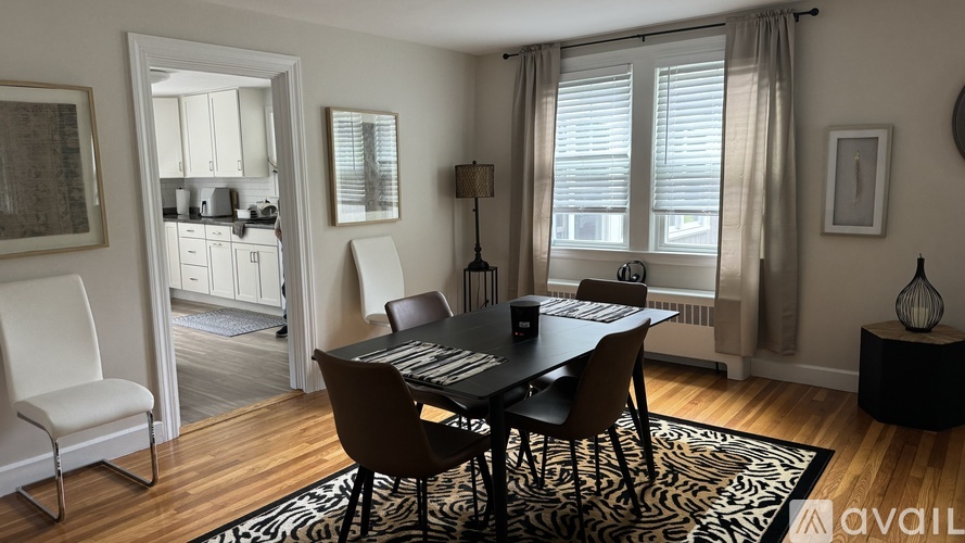 A black and white dining room with a zebra rug.