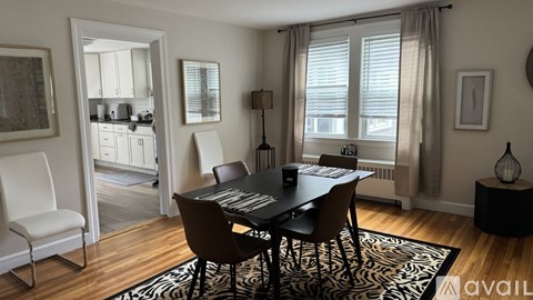 A black and white dining room with a zebra rug.