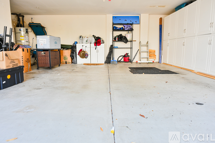 A garage with a lot of storage space and a few items scattered about.