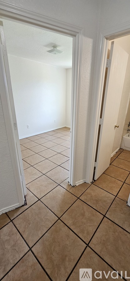 A room with a tiled floor and a ceiling fan.