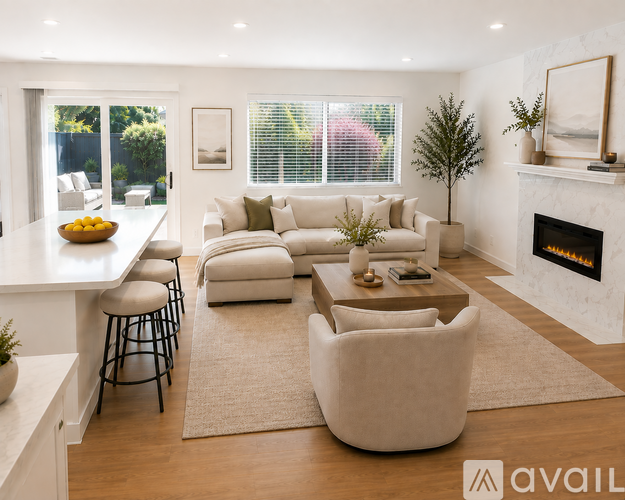 A modern living room with a fireplace and a large window.