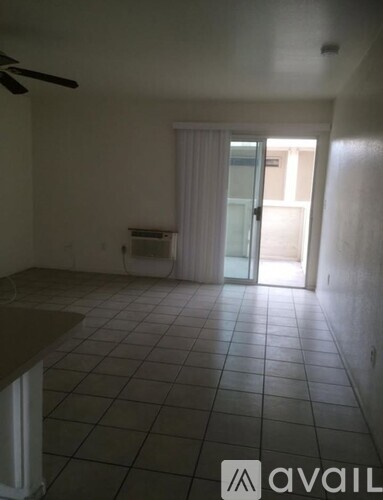 A room with a tiled floor and a ceiling fan.