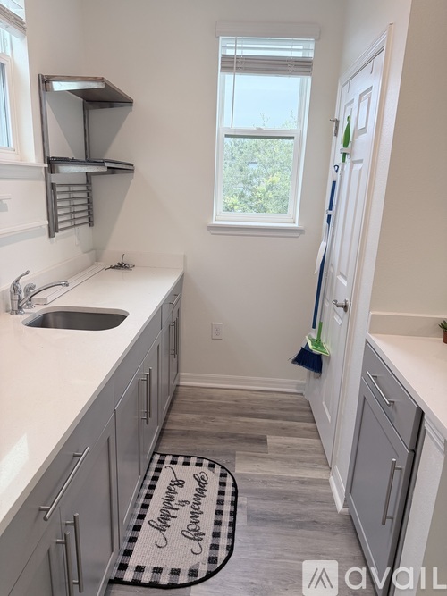 A kitchen with a sink and a window.
