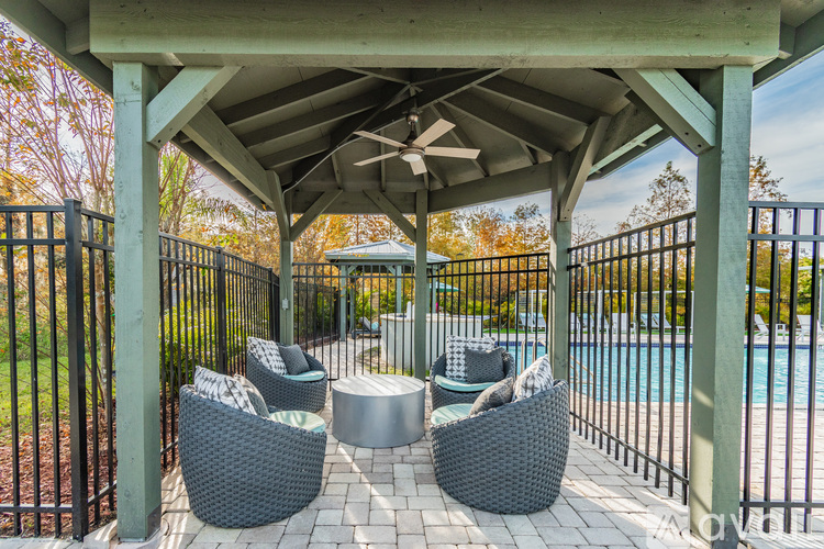 A patio with a pool in the background.