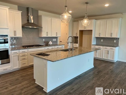A kitchen with a large island in the middle.