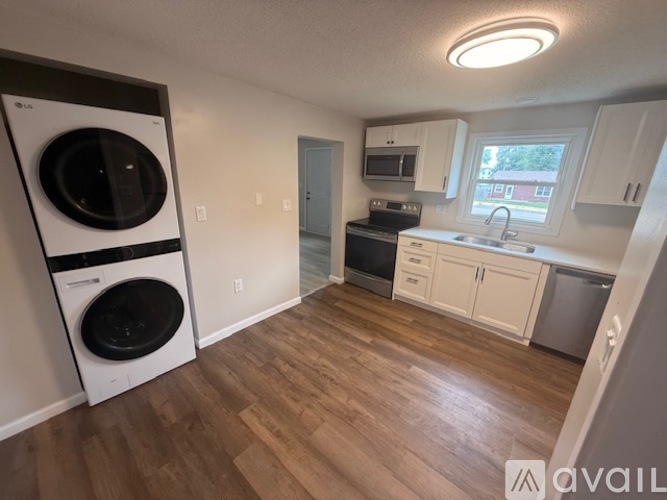 A kitchen with a washer and dryer built in.