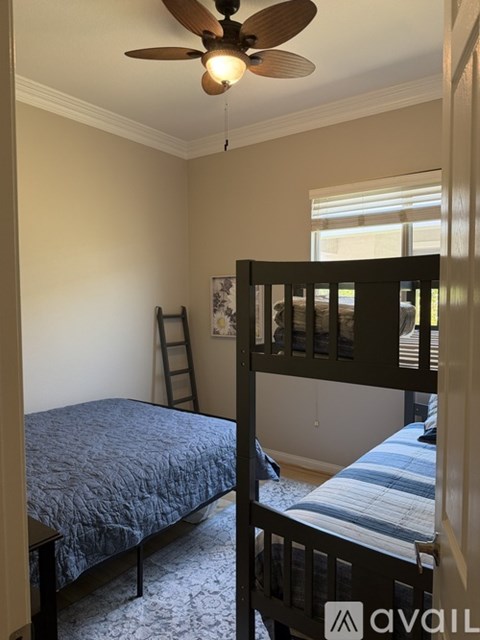 A bedroom with a bed and a bunk bed.