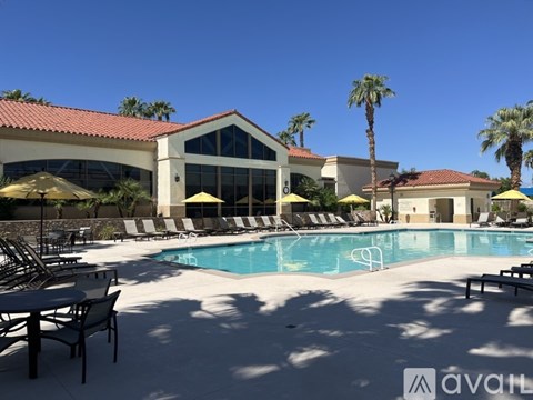 A large building with a pool in front of it.